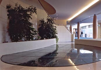 Glass flooring over ornamental fish pond in health Spa